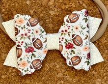 Load image into Gallery viewer, Football Flowers on Cream Layered Leatherette Bow
